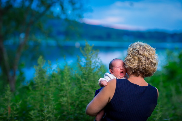 Close-up portrait of a happy baby with bright eyes looking at the camera.