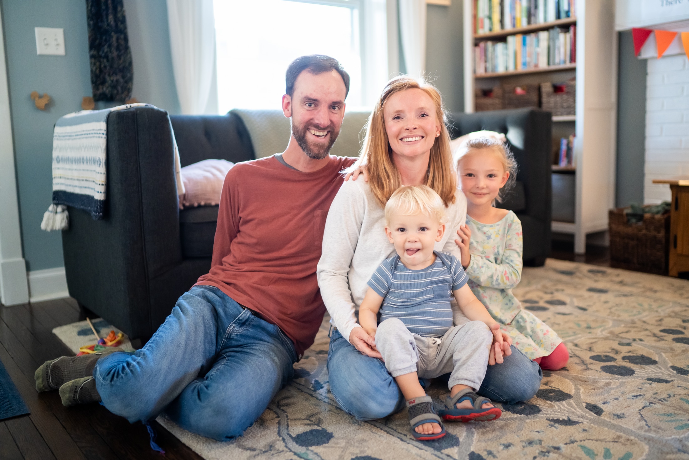 Jancey's family sharing a sweet moment in their sunny living room, love and laughter radiating.