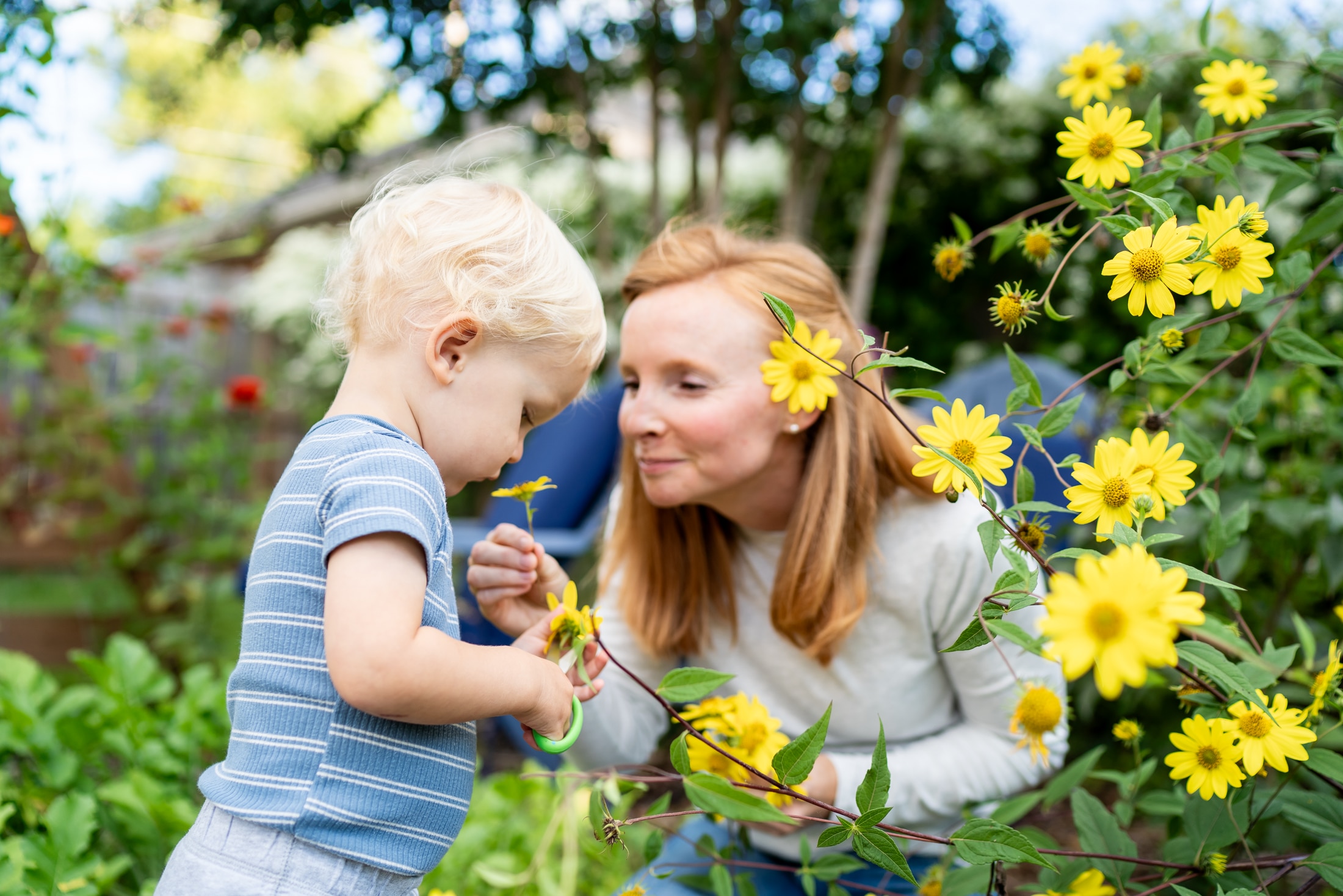 Flower power: Jancey's little girl adorning her parents with backyard blooms, the epitome of family fun.