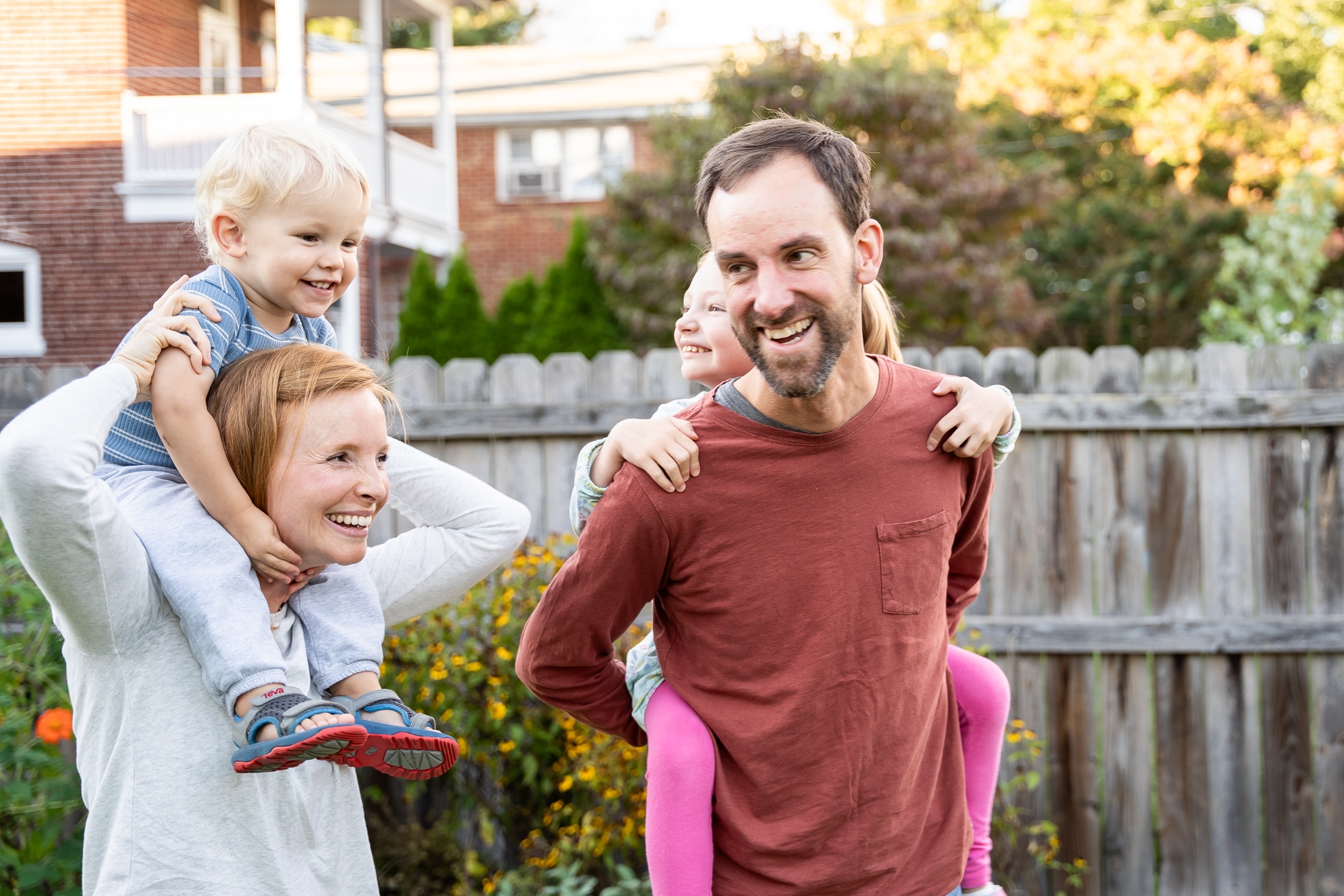 A grand finale: Both kids perched atop mom and dad's shoulders, radiating pure joy.