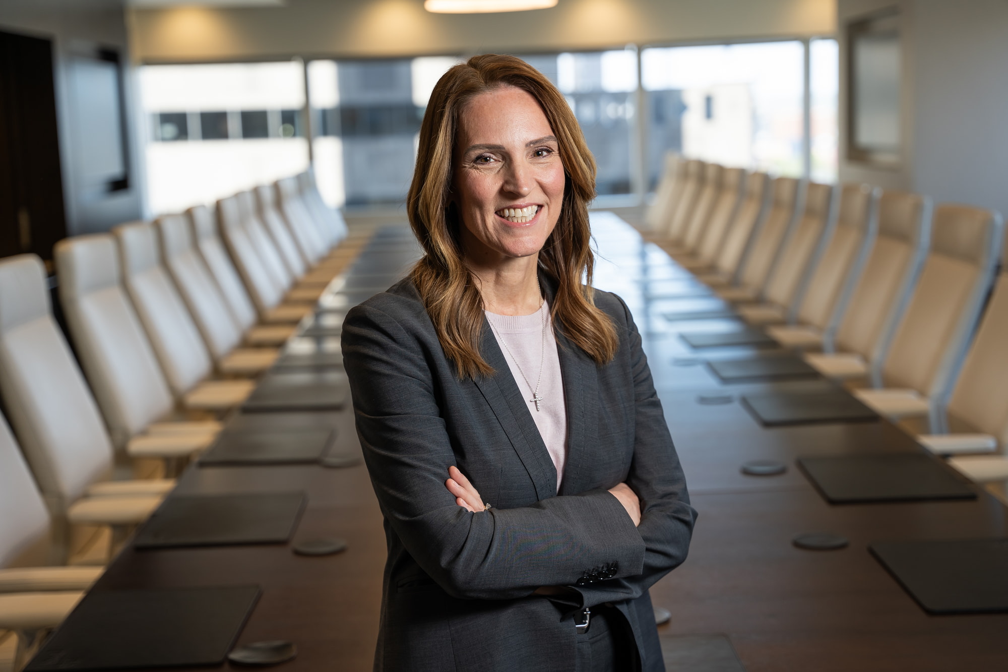 An executive business woman standing in a office board room