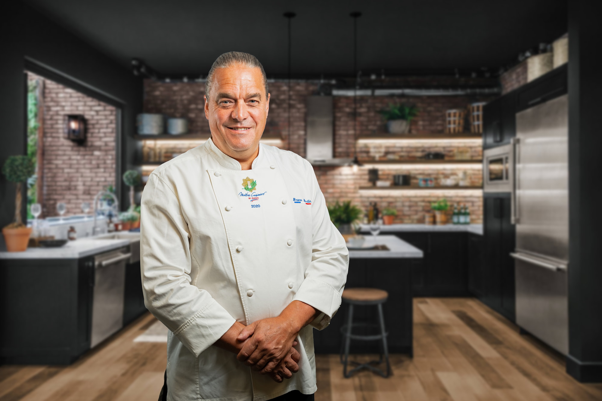 A professional food chef in the kitchen posing for a headshot brand photo