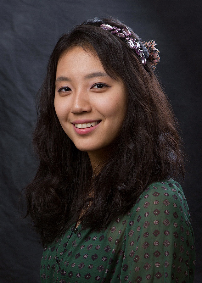 a high school senior posing for a traditional yearbook headshot