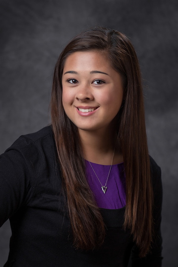 a high school senior posing for a traditional yearbook headshot