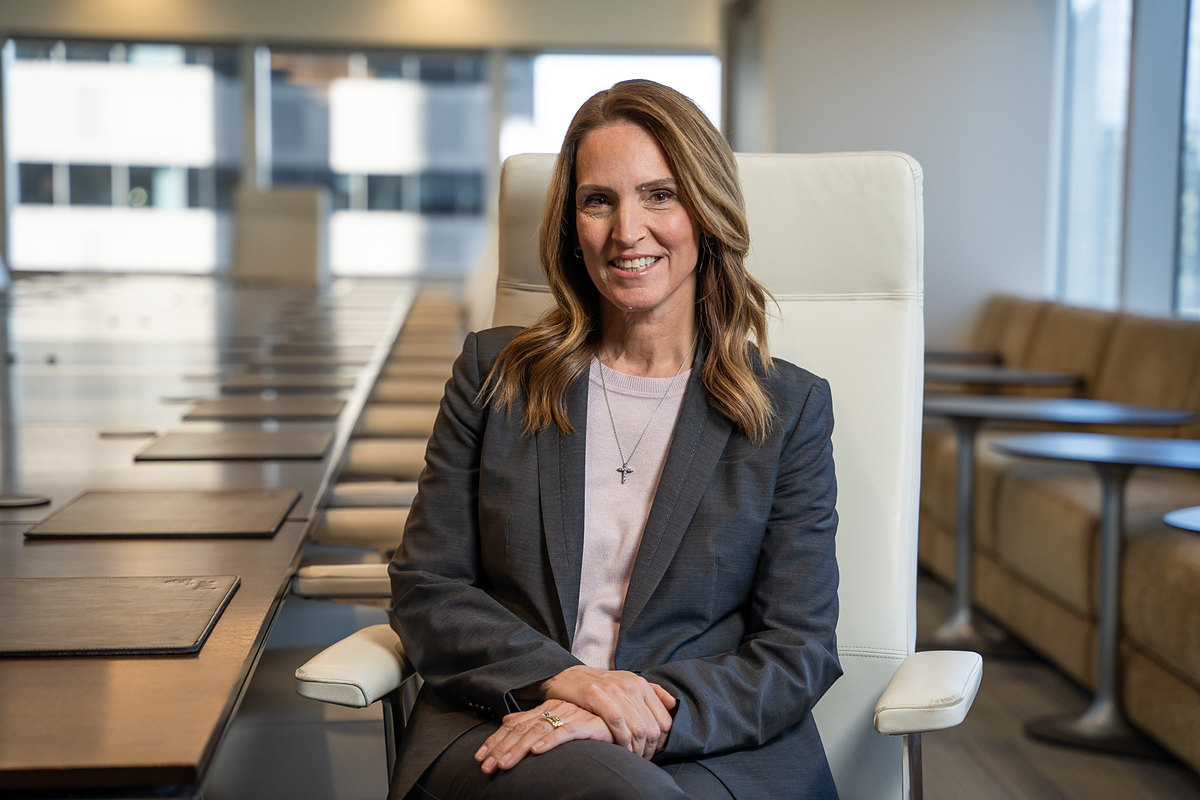 Executive seated in a white leather boardroom chair