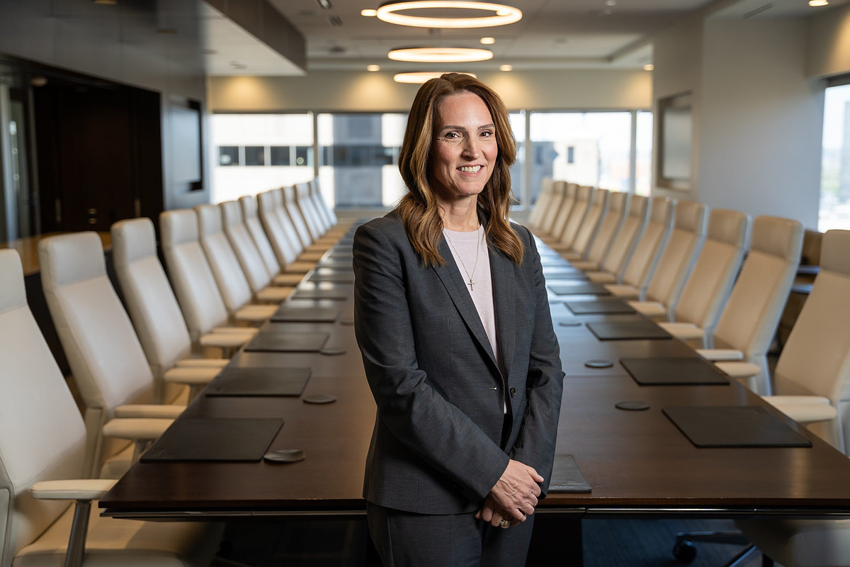 Executive standing in a large corporate boardroom
