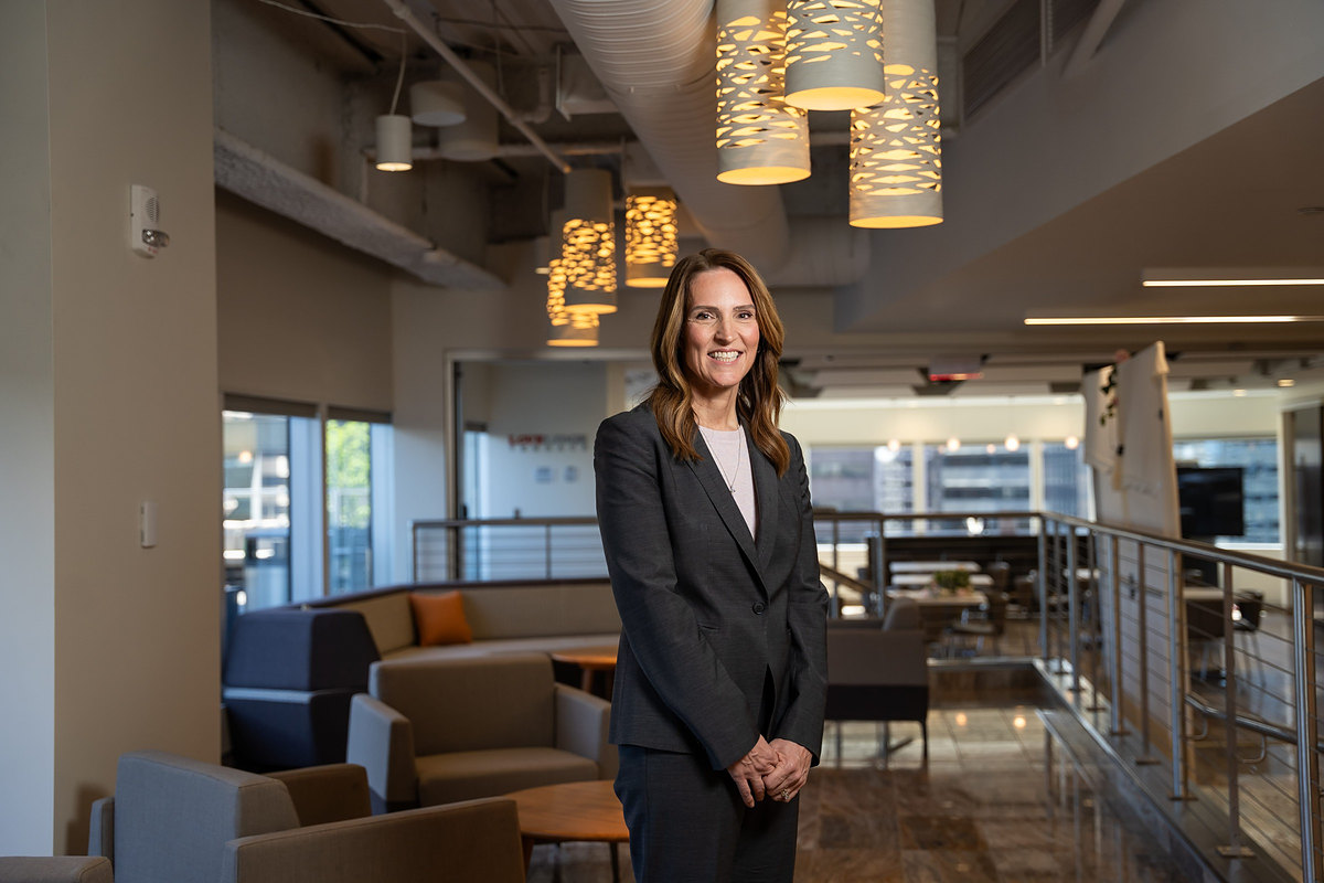 Executive standing in a modern corporate office lounge