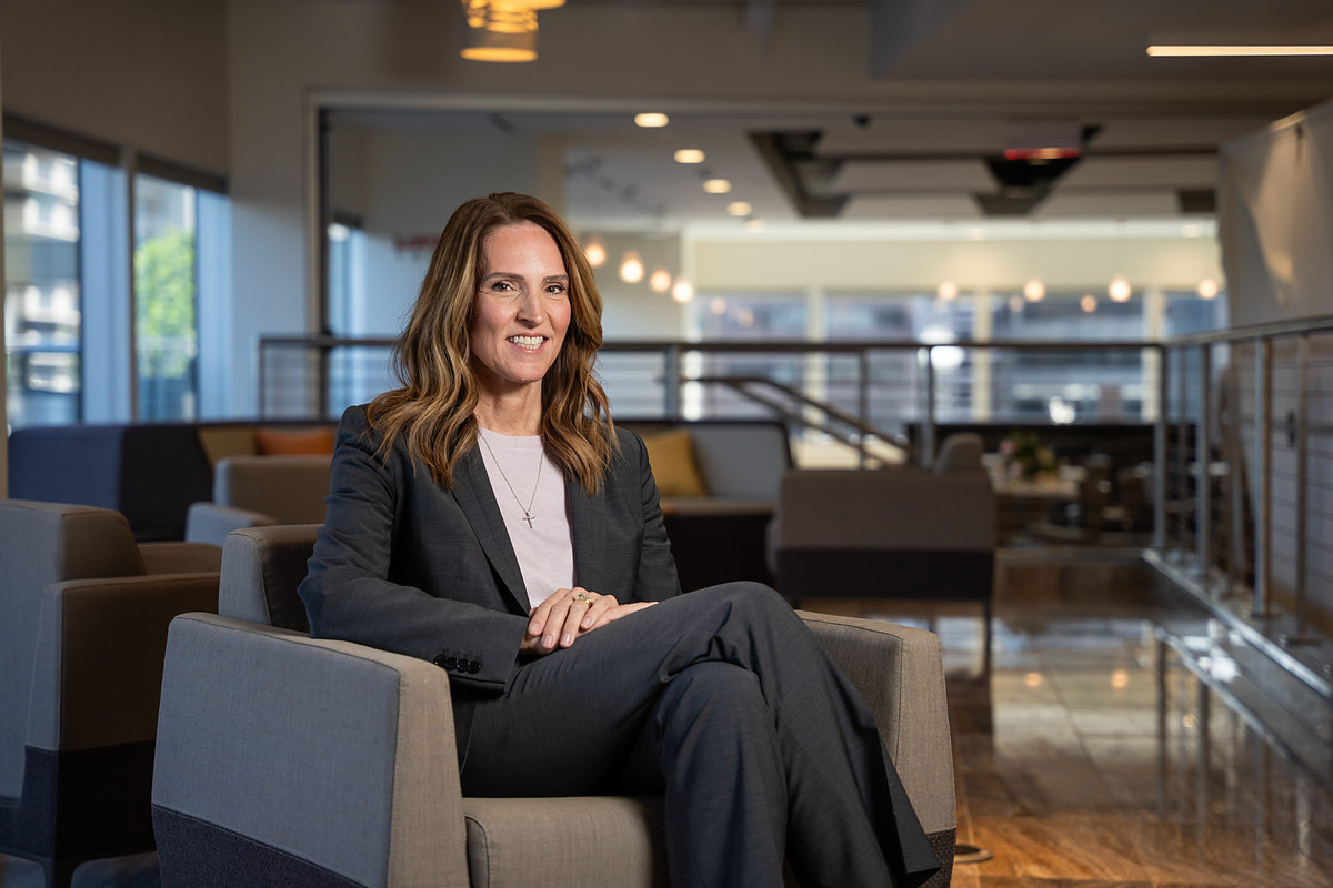 Executive seated in an armchair in a corporate office lounge